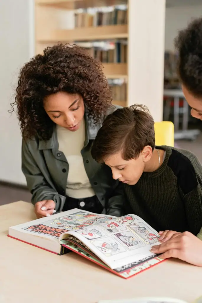 A family engaged in reading a book together at a library table, fostering learning and bonding.